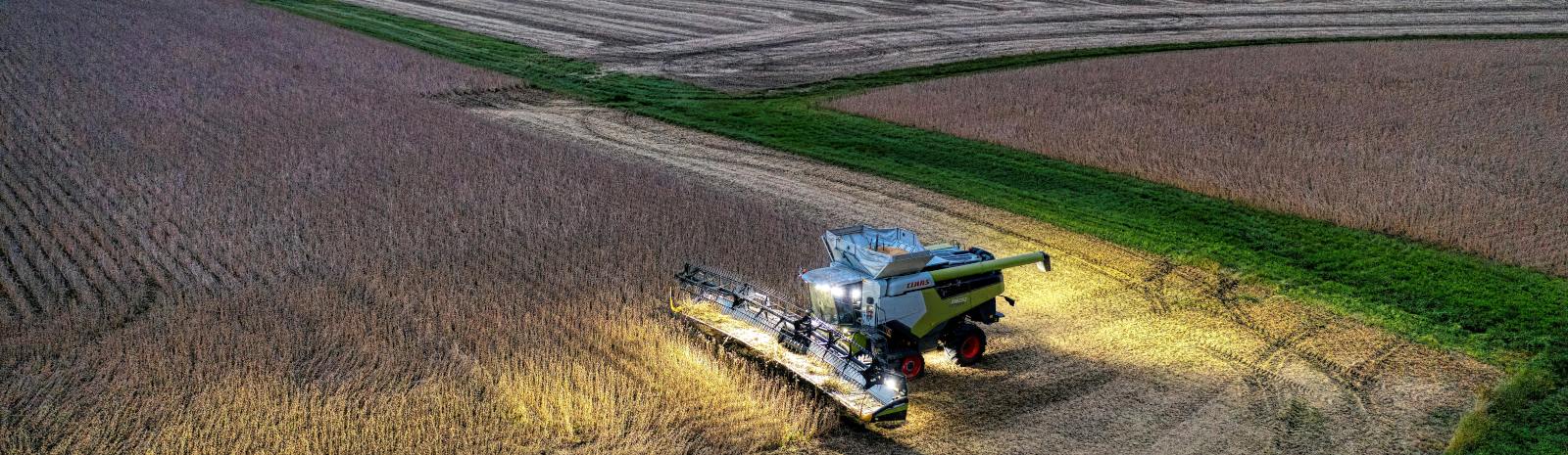 A picture of a tractor being used on a soybean farm.